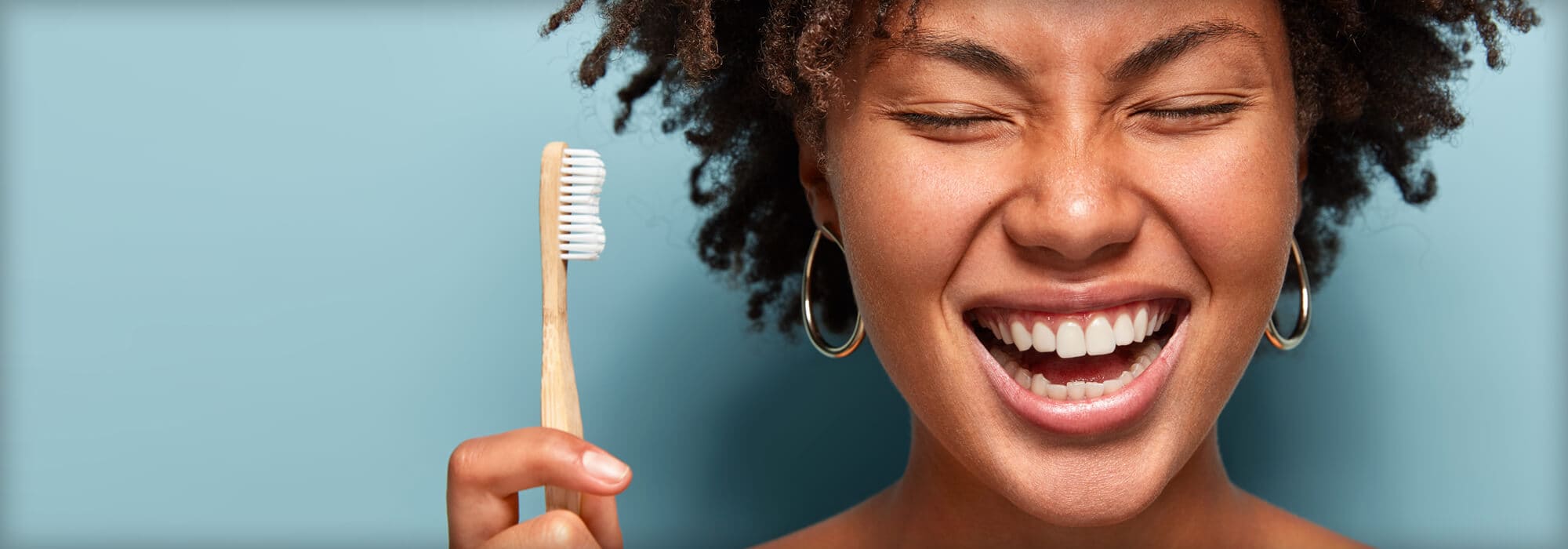happy woman holding tooth brush