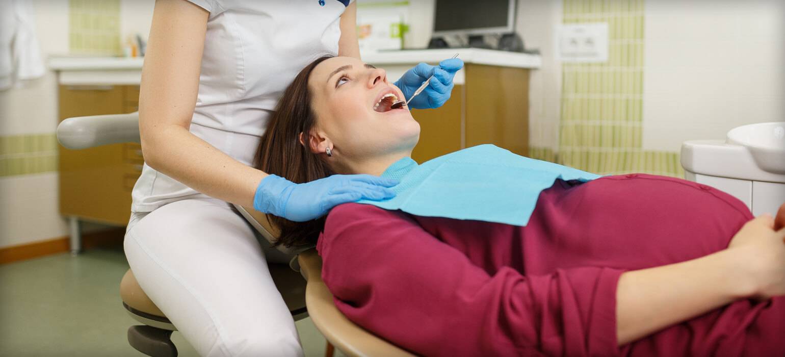 Pregnant woman getting dental exam