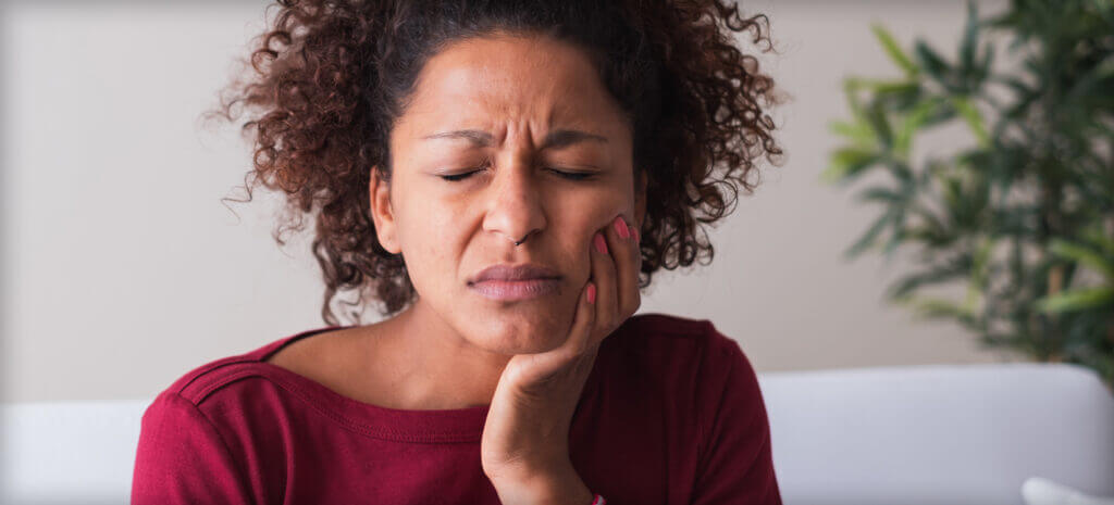 woman holding jaw