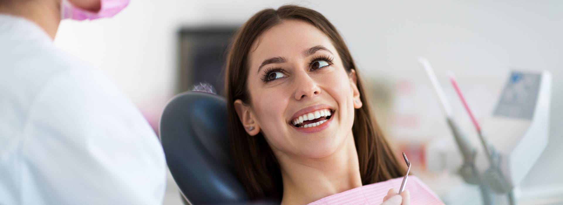 woman smiling during dental exam